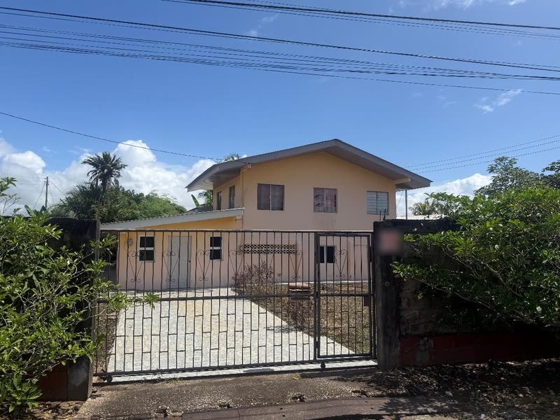 Front from the street, behind the sliding gate