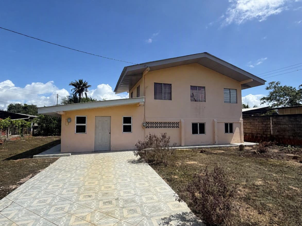 The two-storey house from the front, with its tiled driveway