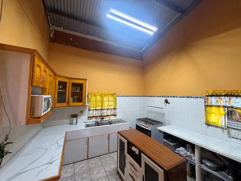 Kitchen with built-in cupboards, tiled counters and a double sink